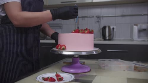 Decorating a Birthday Cake With Strawberries