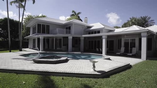 Large White Suburban House With A Backyard Pool