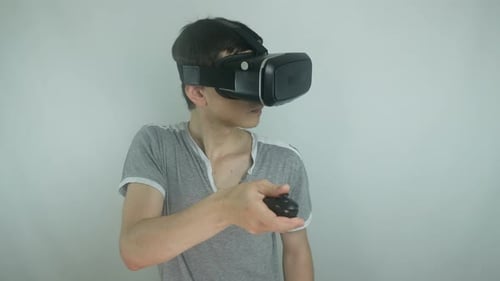 Young Adult Using VR Headset and Controller