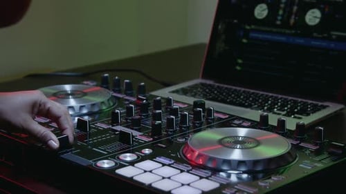 DJ Mixing Music on Controller with Laptop