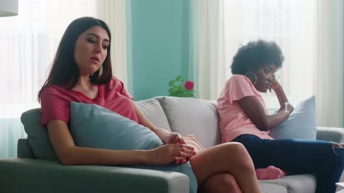 Women Friends Sit On Sofa After Conflict