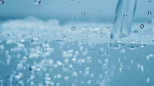 Water Being Poured Into Water, Forming Bubbles