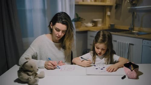 Woman and Child Drawing Pictures at a Table