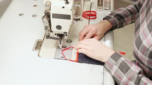 Close Up of Female Hands Sewing Protective Medical Mask