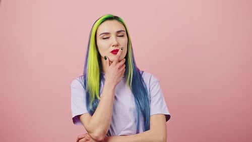 Pensive Young Woman with Colorful Hair Thinking