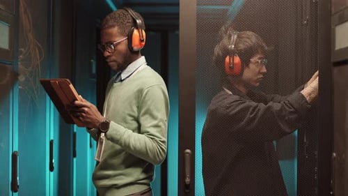Technicians Inspect Data Servers in a Server Room