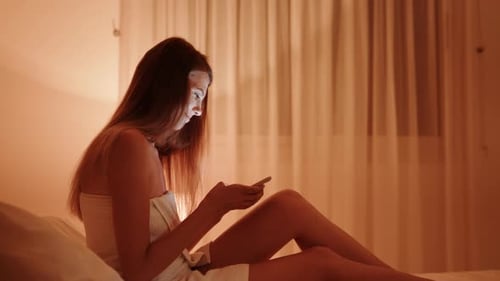 Woman in Towel Excited by News on Phone