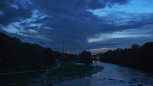 Munich Nature at Dramatic Dusk: Autumn in Park of Tourist Bavarian City. View of Isar River