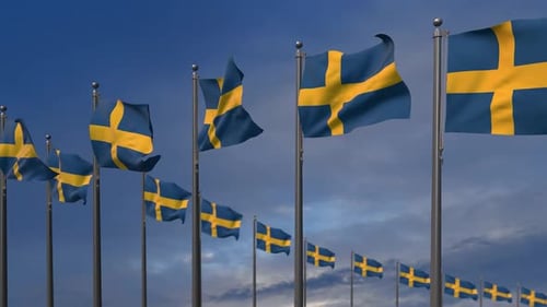 Waving Swedish Flags Against Blue Sky