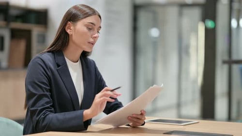 Woman Reading Documents in Office