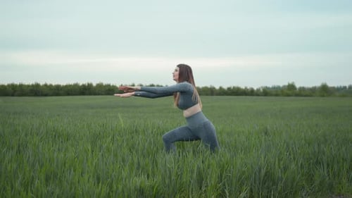Woman Exercising Outdoors in Green Field