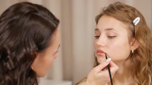 Makeup Artist Applies Lip Liner to Young Woman