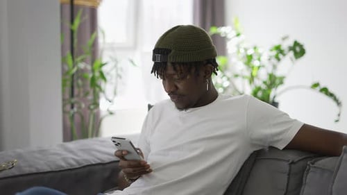 Man Relaxing at Home While Using Phone