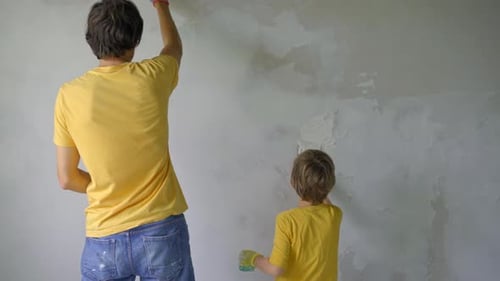 Father and Son Plastering a Wall Together