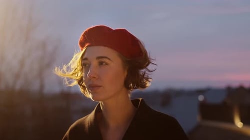 Twilight. Portrait Of Stylish Young Woman In Red Beret. Pretty Woman On The Street.
