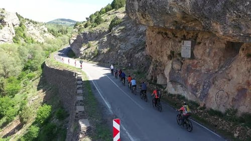 The Cyclists On Bikes Ride Up In The Mountain 2