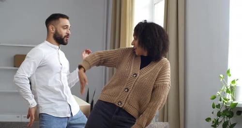 Happy Couple Dancing in New Home Celebration