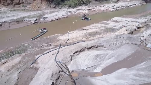 Motion To Grit Miner Standing on Equipment Pumping Wet Sand