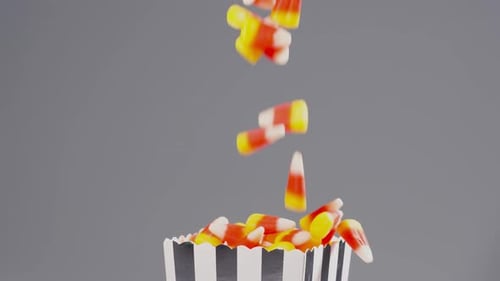 Time for Halloween. Delicious candy corn falls in slow motion.