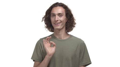 Young Man Gesturing Okay on White Background