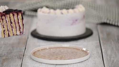 Slice of Berry Cake Being Placed on Plate
