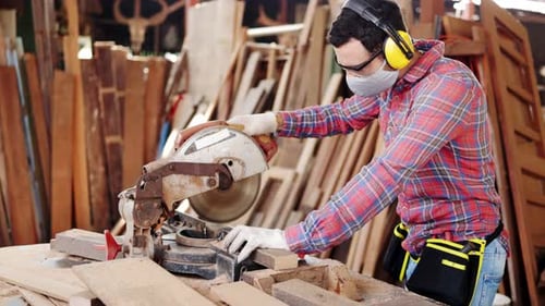 Woodworker Cutting Lumber with Power Saw