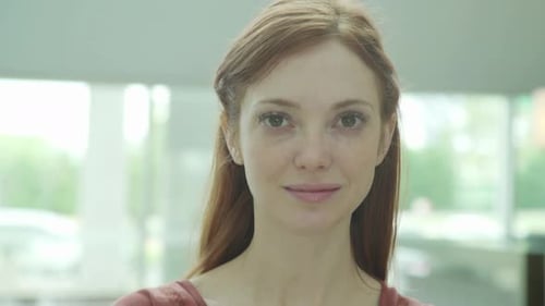 Close Up Portrait of Young Woman Smiling Indoors