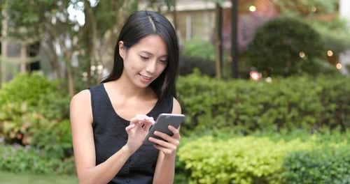 Woman use of smart phone in the park