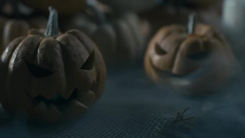 Close-up of Halloween Carved Pumpkins with Smoke