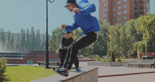 Young Men Performing Parkour Stunts in Urban Park