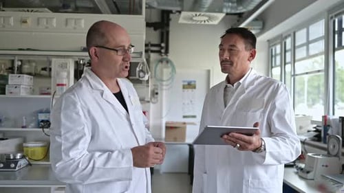 Scientists Discussing Technology in a Modern Laboratory