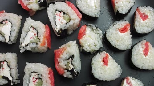 Various Kinds of Sushi Served on a Dark Background
