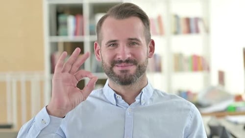 Man Gives OK Gesture and Smiles Confidently