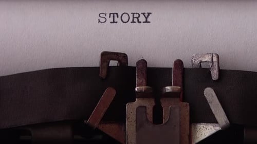 Typing word STORY on retro typewriter. Close up.