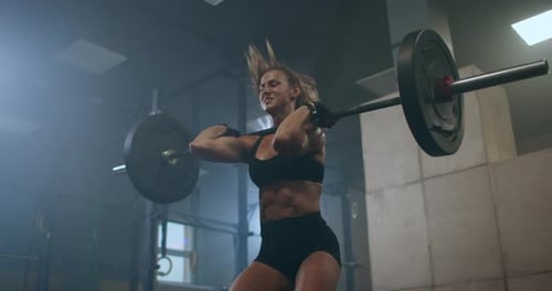 Handsome Muscular Female Does Deadlift and Curls with a Heavy Barbell. Athletic Shirtless Woman
