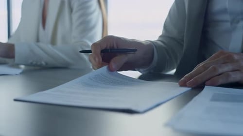 Closeup Hands Checking Agreement in Office