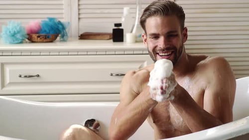 Man Blowing Bubbles in Tub