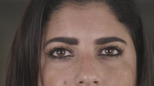 Extreme close up shot of an adult womans eyes. Portrait shot, brunette woman.