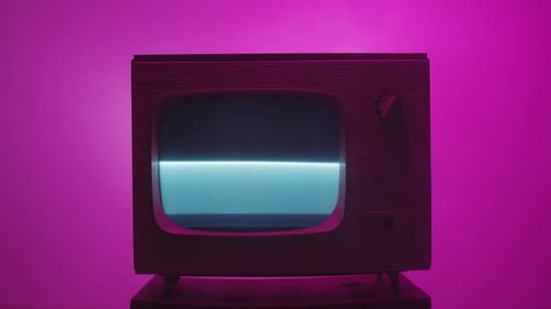 Vintage Television with Static on Screen in Pink Room
