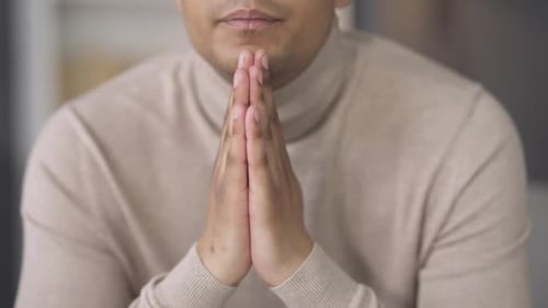 Adult with Hands Clasped in Prayer