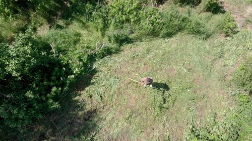 a Black Man Removes the Field From the Grass