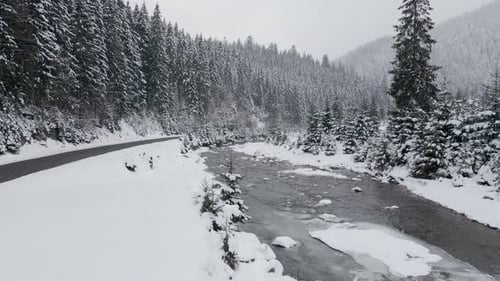 Aerial View Drone Moving Above the Frozen River in Mountains