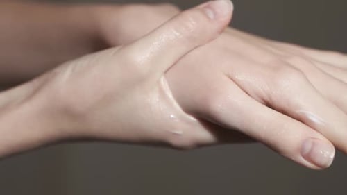 Applying Cream to Hands for Self-Care Routine