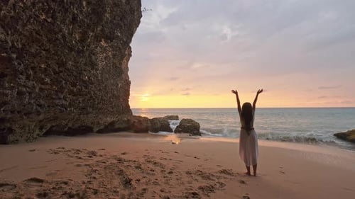 Happy Woman Stand on Sand of the Sea and Show Hand in To Sky. Subject Is Blurred. Woman Expressing