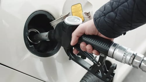 Hand Puts Diesel Fuel Pump Into Car
