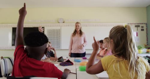 Enthusiastic Students Raising Hands in Classroom Setting