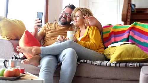 Couple Relaxing on Couch Video Chatting