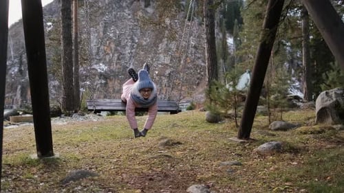 Young Girl Swings in Autumn Forest