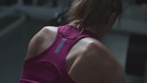 Woman Lifts Weights in a Gym Close Up