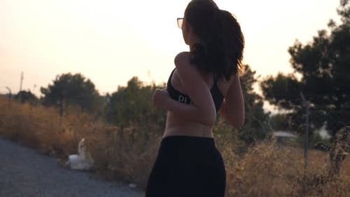 Follow to Sporty Girl Jogging in Country Road